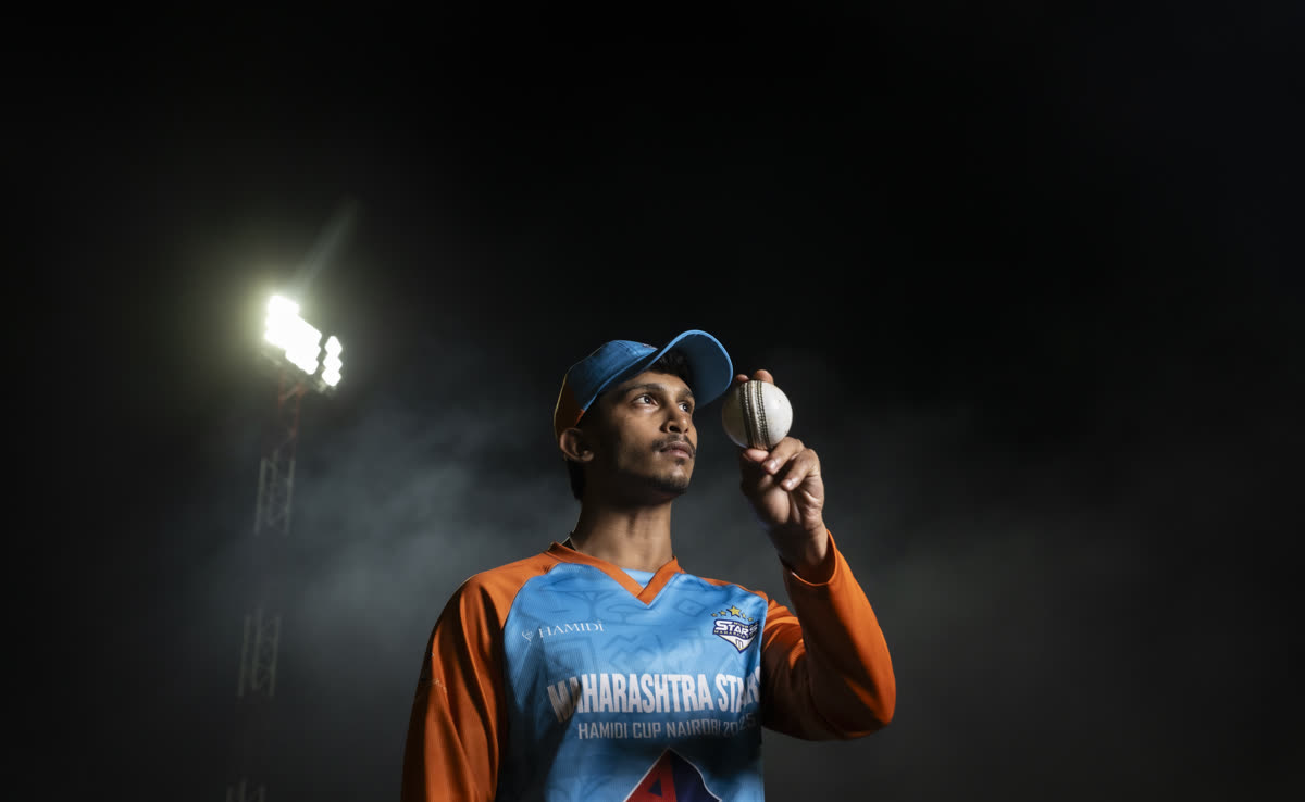Cricket player portrait under floodlights at a sports event