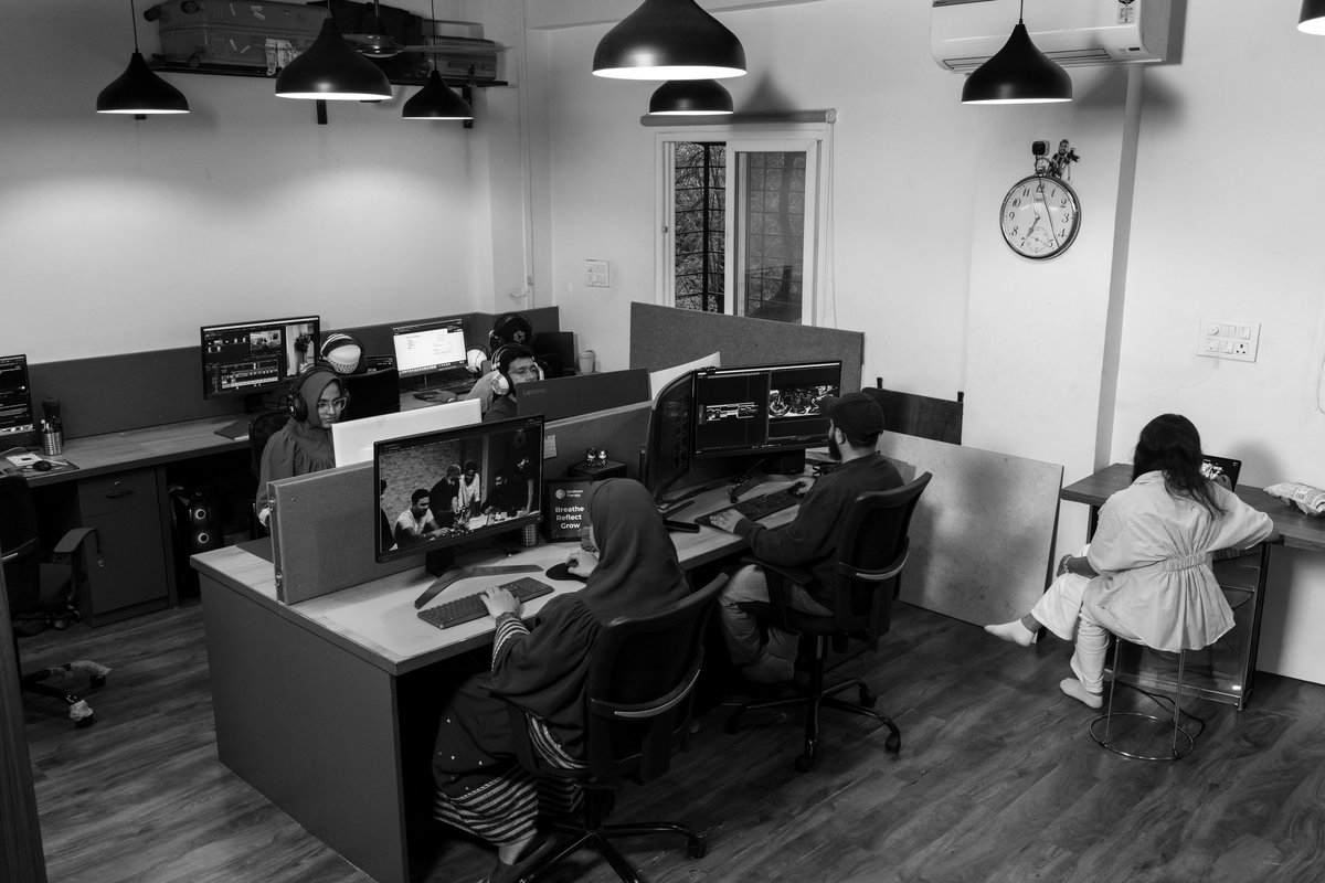 Editors working at rows of workstations on the edit floor